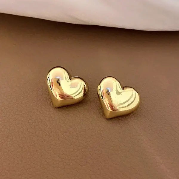 Charming gold heart stud earrings for women, featuring a smooth, polished design perfect for adding a touch of love to any outfit.