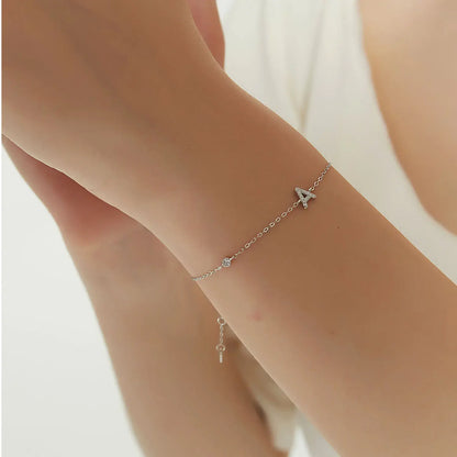 Silver letter S bracelet on the hand of a fashionable beauty