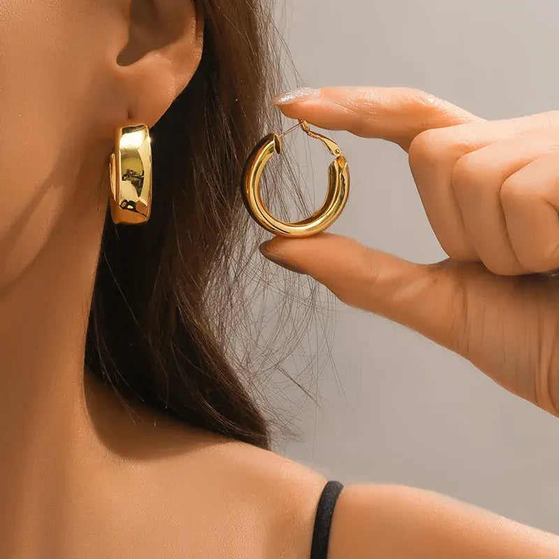 Sleek gold hoop earrings for women, featuring a chunky and modern design, perfect for everyday wear or special occasions.
