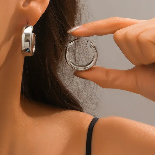 Sleek silver hoop earrings for women, featuring a chunky and modern design, perfect for everyday wear or special occasions.