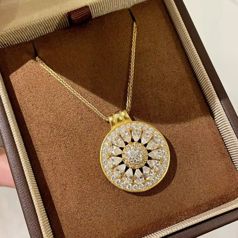 Zircon flower pendant necklace displayed in a brown jewelry box